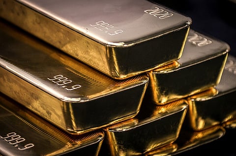 FILE PHOTO: Gold bullion bars (Photo by DAVID GRAY / AFP)