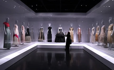 A person attends the media preview of the Costume Institute "Women Dressing Women" exhibit, at the Metropolitan Museum of Art in New York City on 4 December 2023. (Photo by TIMOTHY A. CLARY / AFP)