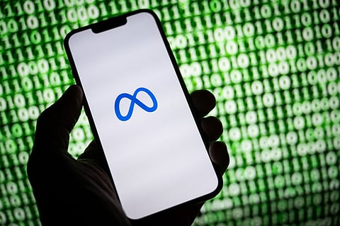 FILE PHOTO: This illustration photo taken on 30 October 2023 shows the Meta (former Facebook) logo on a smartphone in Mulhouse, eastern France. Tech giant Meta on 7 December 2023 was rolling out long-promised end-to-end encryption of chats and calls at Messenger and Facebook. (Photo by SEBASTIEN BOZON / AFP)