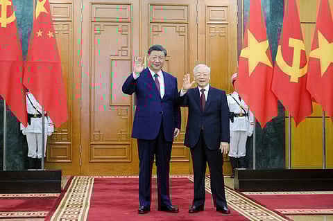 Chinese President Xi Jinping (L) and Vietnamese Communist Party General Secretary Nguyen Phu Trong (R) pose at the Central Office of the Communist Party of Vietnam in Hanoi on December 12, 2023.