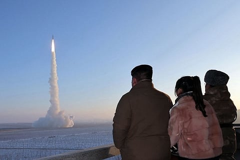 FILE PHOTO: This undated picture released by North Korea's official Korean Central News Agency (KCNA) on 19 December 2023 shows North Korean leader Kim Jong Un (L) and his daughter watching the test launch of a Hwasongpho-18 intercontinental ballistic missile (ICBM) at an undisclosed location in North Korea. (Photo by KCNA VIA KNS / AFP)