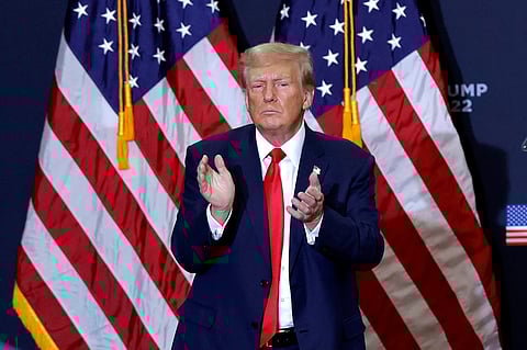 (FILES) Former US President and 2024 presidential hopeful Donald Trump applauds at the end of a campaign event in Waterloo, Iowa, on 19 December 2023.
