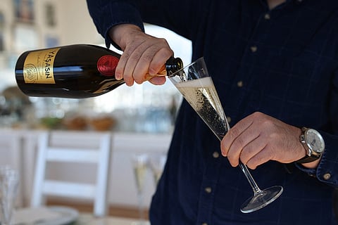 A glass of sparkling wine is poured into a glass at the Vinkara winery, in Kalecik in the district of Ankara Province on 18 December 2023. Turkish sparkling wines make a surprising breakthrough at home and abroad, and are becoming an indispensible complement of festive tables in the hands of producers who rely on indigenous grape varieties. Vinkara was the first house in Turkey to start producing in 2009 sparkling wines using the traditional Champagne method from its vines in Kalecik, 80 kilometers (50 miles) from the capital Ankara. (Photo by Adem ALTAN / AFP)