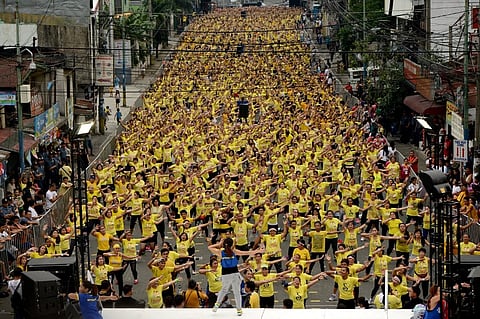 FILE PHOTO: Filipino residents participate in a Zumba class in an attempt to break the Guinness World Record in Mandaluyong on 19 July 2015. Residents broke the record for the largest Zumba class with 12,975 participants in a single venue. (Photo by NOEL CELIS / AFP)