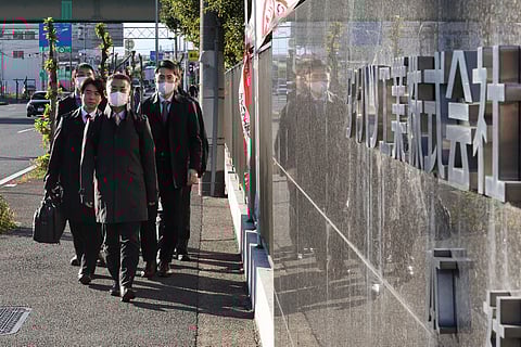 STR/JIJI Press/Agence France-Presse
Officials from Japan’s Ministry of Land, Infrastructure, Transport and Tourism arrive at the Daihatsu Motor headquarters for inspection work in Ikeda, Osaka prefecture on 21 December. The Toyota subsidiary said on 20 December it will suspend shipments of all car models in Japan and abroad, following news it had rigged safety tests.