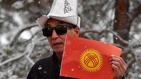 Kyrgyzstan's flag, adopted in 1992 after the Soviet collapse, currently features a yellow orb -- representing a traditional nomadic yurt -- against a red background, surrounded by lines emanating from the center. (Photo: VYACHESLAV OSELEDKO / AFP/File)