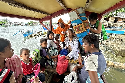 Earthquake-affected residents ride a boat as they evacuate from Hinatuan, Surigao del Sur province on 3 December 2023, following a 7.6 magnitude quake late on 2 December. (Photo by AFP)