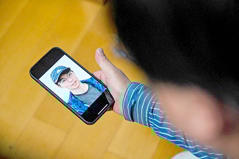 HECTOR RETAMAL/Agence france-presse
SEAKOO Wu watches a video created with artificial intelligence showing the face and voice of his dead son. The avatar said words that the late student never spoke.