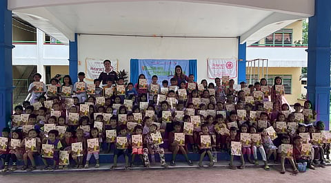 Rotaract Club of Makati president Emmanuel Adrian Manuel (standing, left) and RAC Zamboanga City West president Ma. Theresa Lanelle C. Bañez (standing, right), with students of Tulungatung Elementary School, Zamboanga City during the launching of Project BTS. | PHOTOgraph courtesy of Rotaract Club of Makati