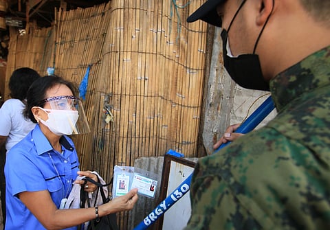 FILE: People show their vaccination cards upon entering Quinta Market in Palanca St., Quiapo,Manila that has been closed off to the public ahead of the Feast of the Black Nazarene on 9 January 2020. | Photo by Bob Dungo Jr.