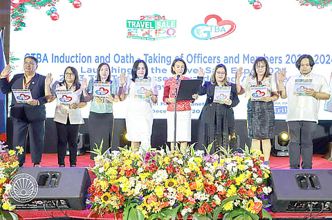 (4th and 5th from left) Ms. Michelle Taylan, President and Founder of Global Tourism Business Association (GTBA) and Tourism Secretary Christina Frasco administer the oath-taking of the new GTBA board members.