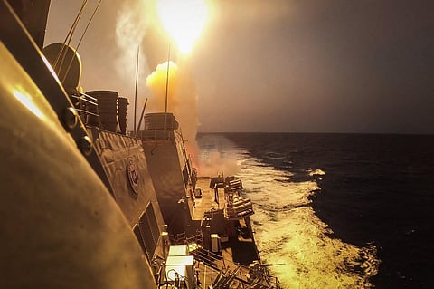 FILE PHOTO: This handout picture courtesy of the US Navy taken on.19 October 2023 shows the Arleigh Burke-class guided-missile destroyer USS Carney (DDG 64) defeating a combination of Huthi missiles and unmanned aerial vehicles in the Red Sea. (Photo by Aaron Lau / US NAVY / AFP)