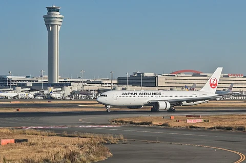 FILE PHOTO: This photo taken on 29 December 2023 shows a Japan Airlines (JAL) passenger plane taxiing past the control tower after its arrival at Tokyo International Airport at Haneda in Tokyo. (Photo by Richard A. Brooks / AFP)