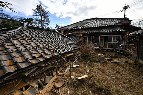 Collapsed wooden houses are seen in Shika Town, Ishikawa prefecture on 2 January 2024, a day after a major 7.5 magnitude earthquake struck the Noto region in Ishikawa prefecture in the afternoon. (Photo by Kazuhiro NOGI / AFP)