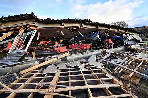 Agricultural machinery and other equipment are seen trapped under a collapsed wooden house in Wajima, Ishikawa prefecture on 2 January 2024, a day after a major 7.5 magnitude earthquake struck the Noto region in Ishikawa prefecture in the afternoon. (Photo by Kazuhiro NOGI / AFP)