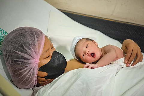 First-born Ronalyn Concepcion, 23, from Cavite gives birth to a son, Jhaiden Railey, at 12 midnight on 1 January 2024 at Dr. Jose Fabella Memorial Hospital. With hope and perhaps a dose of trepidation, this new parent holds her child gently in her arms. | PHOTOGRAPH BY YUMMIE DINGDING FOR THE DAILY TRIBUNE @tribunephl_yumi
