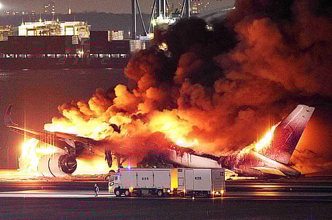 FLAMES engulf a Japan Airlines plane at the runway of Haneda Airport on Tuesday, 2 January, after apparently colliding with a Coast Guard aircraft. Five of the six crew members of the Coast Guard plane died, while all 379 aboard the JAL flight survived. | JIJI PRESS VIA STR/AGENCE FRANCE-PRESSE