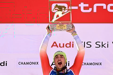 First placed Switzerland's Daniel Yule celebrates on the podium with his award after winning the Men's Slalom event during the FIS Alpine ski World Cup in Chamonix, on 4 February 2024. (Photo by Jeff PACHOUD / AFP)