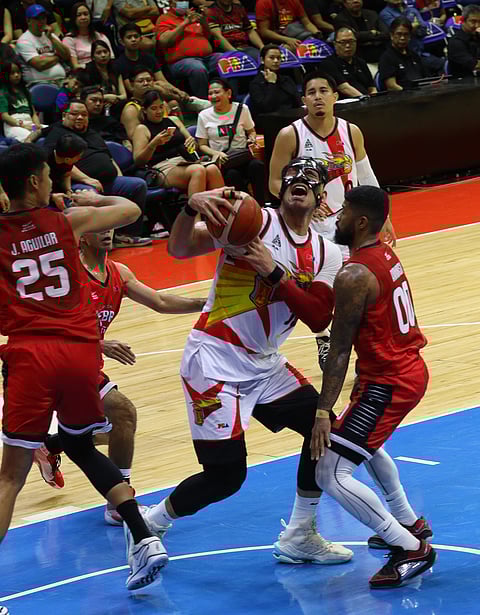 San Miguel Beer center June Mar Fajardo charges against the swarming defense of Barangay Ginebra during their PBA Philippine Cup encounter on Friday. (Joey Mendoza)