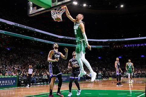 KRISTAPS Porzingis posts a double-double as the NBA-leading Boston Celtics escape the Sacramento Kings, 101-100, for their fourth straight win. | BRIAN BABINEAU/AGENCE FRANCE-PRESSE