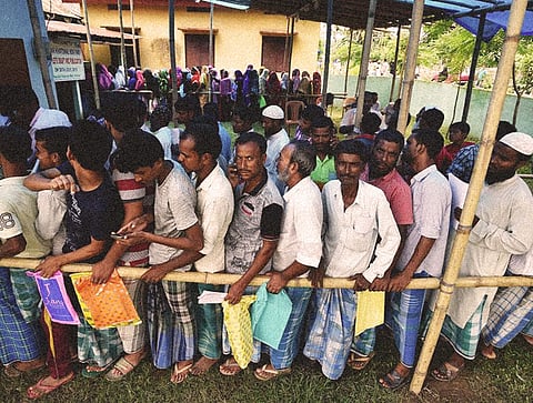 People standing in queue while the National Register of Citizens (NRC) exercise, aimed at identifying illegal immigrants is being carried out.