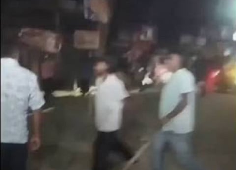 Screengrab from the viral video showing attackers assaulting the Bihu troupe with sticks.