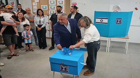 Gadi Eisenkot, leader of the Yashar ("Straight") party, and his wife, Hannah Eisenkot, cast their ballots at a polling station during Israel's general election in Herzliya, Israel.