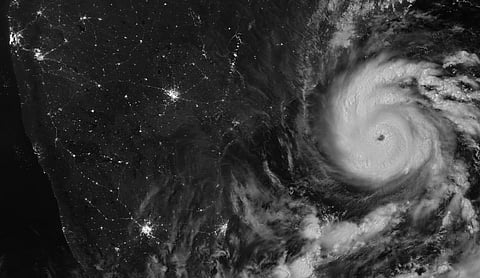 Night-time satellite image of Cyclone Arnab over the Bay of Bengal, its eye offshore, with the city lights of coastal India visible to the west.
