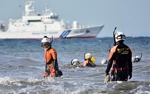 Frogmen join body hunt as Japan typhoon tolls hit 24