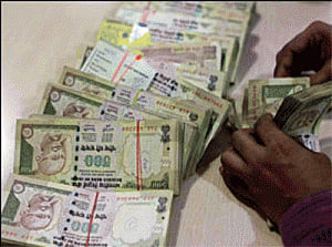 Rupee trims initial gains, still up by 14 paise Vs dollar