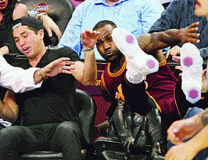 leBron rams into Day's wife during game