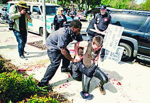 3 stabbed, 13 held at KKK rally