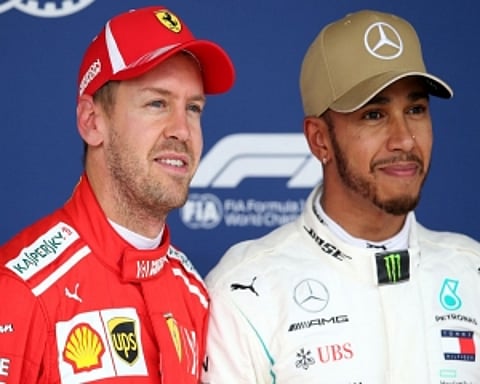 Foes Hamilton and Vettel swap helmets