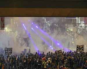 Second night of tear gas as Hong Kong protesters defy China warnings