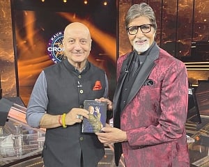 Anupam Kher gifts his latest book to Amitabh Bachchan