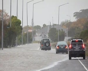Flood recedes in New Zealand, leaving debris, broken bridge