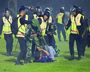 125 die as tear gas sets off rush at soccer match