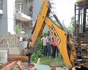 Bulldozer removes illegal structures outside politician Shrikant Tyagi's Noida flat