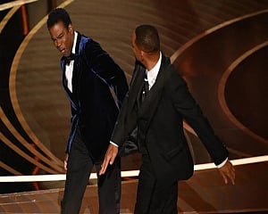 Chris Rock gets standing ovation at comedy show, says will talk about Oscars slap 'at some point'