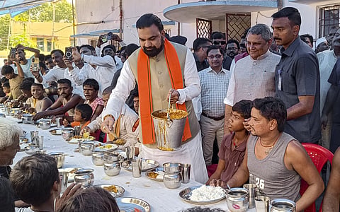 Bihar Chief Minister Samrat Choudhary serves food to flood-affected people at a relief camp in Saran, PATNA on Monday, September 7. (PTI Photo)