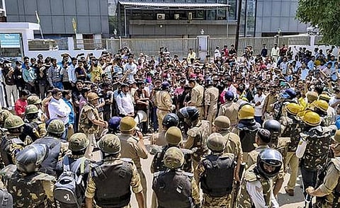 Workers gathered during a protest in Noida demanding higher wages. PTI photo