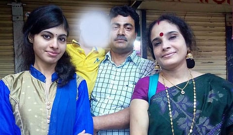 File photo: Three people pose in front of a closed metallic shutter, one woman in a green patterned sari, DHAKA. (PTI Photo)