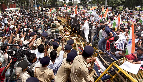 Students clash with police personnel during a march demanding cancellation of the 70th BPSC exam in Patna, Tuesday, August 25. (PTI Photo)