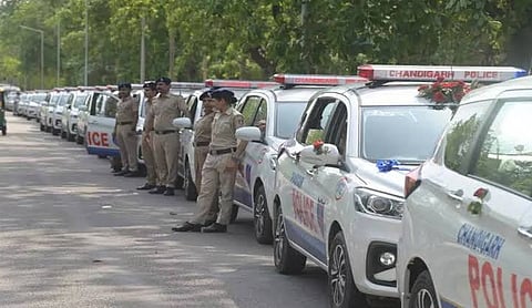 File photo: Chandigarh Police personnel stand beside patrol vehicles on a road. (PTI Photo)