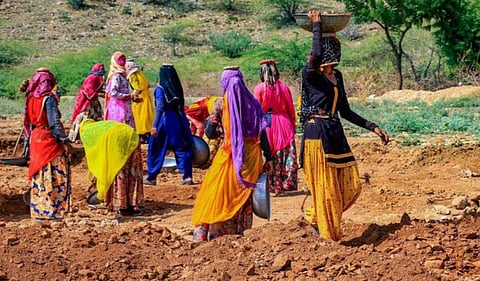 Rural women work at a site under a rural employment programme. PTI image