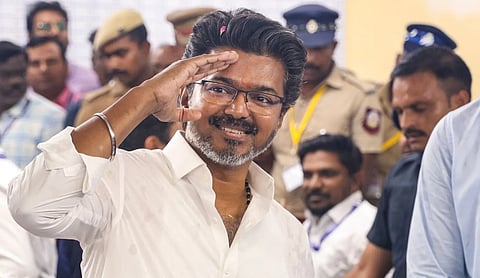 File photo of Tamil Nadu Chief Minister C Joseph Vijay greeting supporters. PTI Photo, CHENNAI. (PTI Photo)