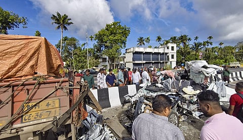 People gather near wreckage of a car after it collided with a lorry parked on the highway at Kaipamangalam, in Thrissur district, Keralam, Saturday, Sept. 5, 2026. (PTI Image)