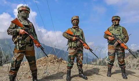 Representational image: Assam Rifles personnel in camouflage fatigues carrying rifles stand along a hill road in the Northeast. (via X.com)
