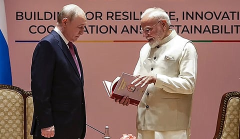 Prime Minister Narendra Modi presents a Russian translation of the Thirukkural to Russian President Vladimir Putin during their meeting at Bharat Mandapam in New Delhi.