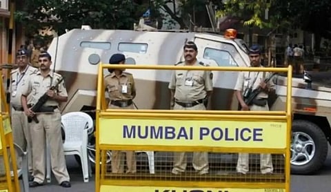 File photo: Police personnel stand behind a security barricade in Mumbai, THANE.